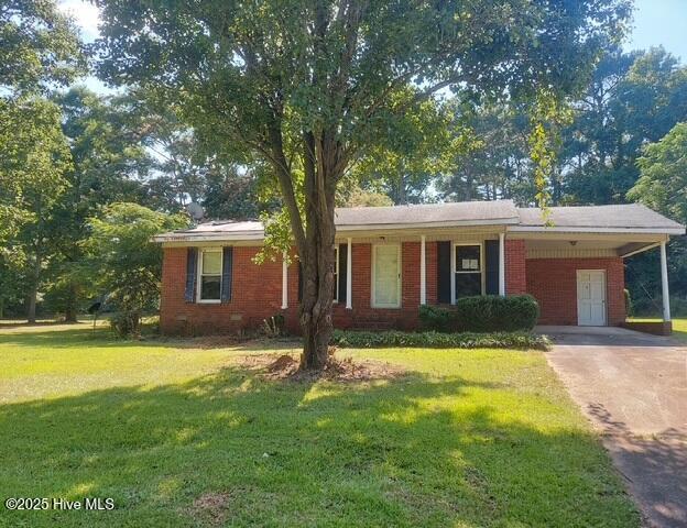 1522 Parson Grove Church Rd, Wadesboro, NC 28170 - single story home with driveway, a front yard, brick siding, and a carport