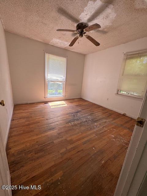 1522 Parson Grove Church Rd, Wadesboro, NC 28170 - spare room featuring hardwood / wood-style floors, a textured ceiling, and a ceiling fan