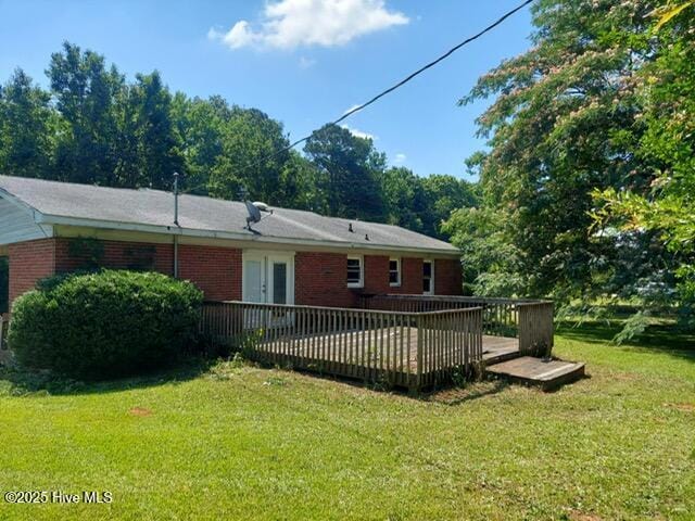 1522 Parson Grove Church Rd, Wadesboro, NC 28170 - rear view of property featuring a lawn, a wooden deck, and brick siding
