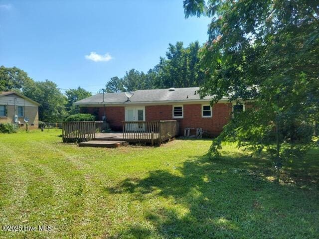 1522 Parson Grove Church Rd, Wadesboro, NC 28170 - rear view of house with a deck, a lawn, and brick siding