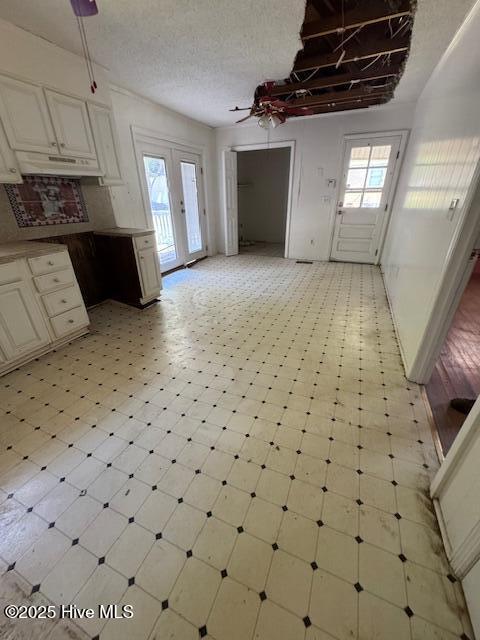 1522 Parson Grove Church Rd, Wadesboro, NC 28170 - kitchen featuring under cabinet range hood, open floor plan, light flooring, and a ceiling fan