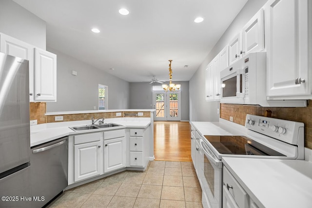 826 Shelton Ct, Wilmington, NC 28412 - kitchen featuring appliances with stainless steel finishes, light countertops, french doors, a peninsula, and recessed lighting