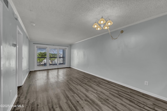 400 Virginia Ave Unit 203B, Carolina Beach, NC 28428 - unfurnished living room featuring a textured ceiling, crown molding, dark wood-style flooring, and a chandelier