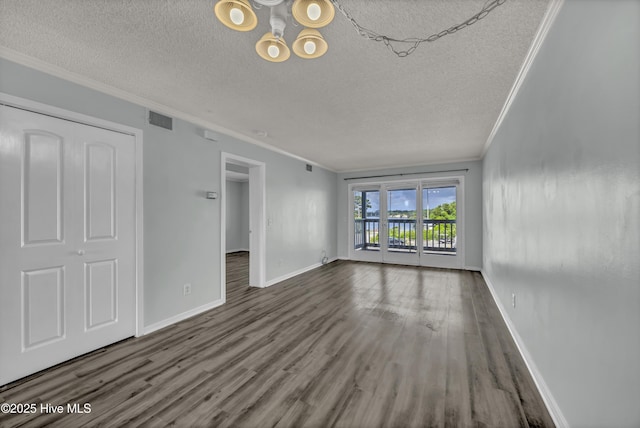 400 Virginia Ave Unit 203B, Carolina Beach, NC 28428 - unfurnished living room featuring crown molding, a textured ceiling, wood finished floors, and a chandelier
