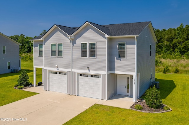 107 Pasture Ln Unit B, Swansboro, NC 28584 - view of front of house featuring concrete driveway, an attached garage, a front yard, and a shingled roof