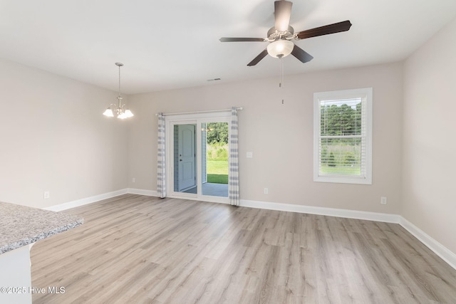 107 Pasture Ln Unit B, Swansboro, NC 28584 - spare room with healthy amount of natural light, light wood finished floors, a chandelier, and ceiling fan