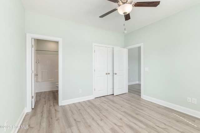 107 Pasture Ln Unit B, Swansboro, NC 28584 - unfurnished bedroom featuring light wood-type flooring, a closet, connected bathroom, and ceiling fan