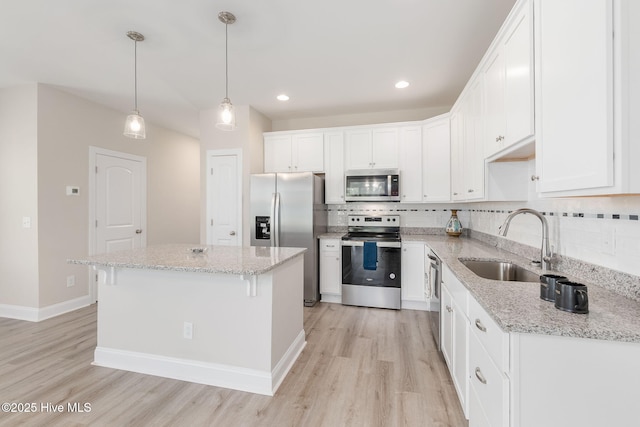 107 Pasture Ln Unit B, Swansboro, NC 28584 - kitchen featuring appliances with stainless steel finishes, light wood-type flooring, tasteful backsplash, white cabinetry, and recessed lighting