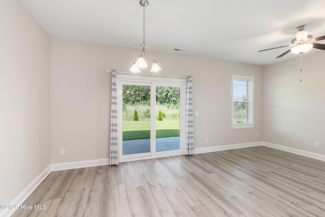 107 Pasture Ln Unit B, Swansboro, NC 28584 - spare room with light wood-type flooring, a chandelier, and ceiling fan