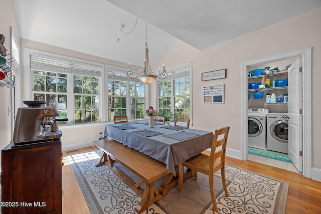 106 Blue Heron Cir, Sneads Ferry, NC 28460 - dining area featuring washing machine and dryer, light wood-style flooring, a chandelier, plenty of natural light, and vaulted ceiling
