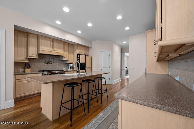 106 Blue Heron Cir, Sneads Ferry, NC 28460 - kitchen with fridge with ice dispenser, backsplash, dark wood finished floors, a kitchen bar, and a center island with sink
