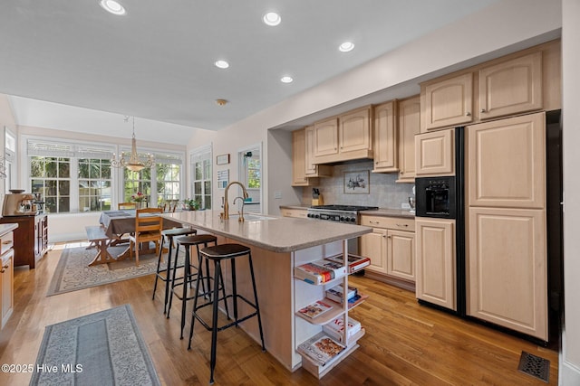 106 Blue Heron Cir, Sneads Ferry, NC 28460 - kitchen with premium appliances, healthy amount of natural light, a kitchen breakfast bar, light countertops, and recessed lighting