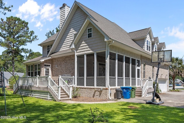 106 Blue Heron Cir, Sneads Ferry, NC 28460 - rear view of house with a sunroom, stairs, brick siding, and a lawn