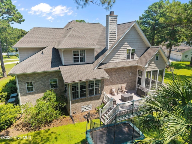106 Blue Heron Cir, Sneads Ferry, NC 28460 - rear view of house with brick siding, a chimney, a yard, and a shingled roof