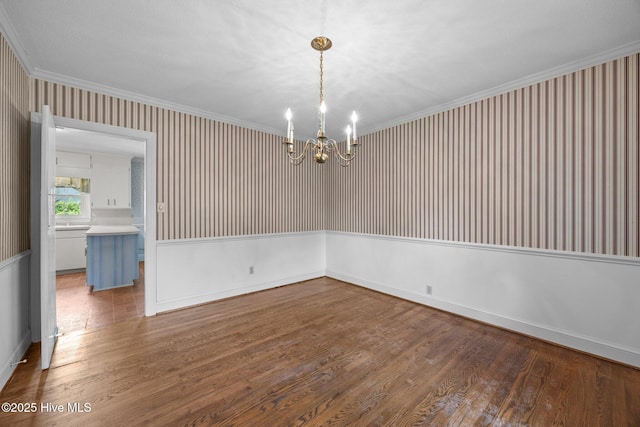 1902 York St, Kinston, NC 28504 - spare room featuring a chandelier, wood finished floors, wallpapered walls, and crown molding