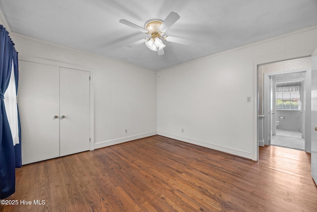 1902 York St, Kinston, NC 28504 - unfurnished bedroom featuring ornamental molding, wood finished floors, a ceiling fan, a closet, and a textured ceiling