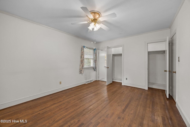 1902 York St, Kinston, NC 28504 - unfurnished bedroom featuring wood finished floors, ornamental molding, a ceiling fan, and two closets