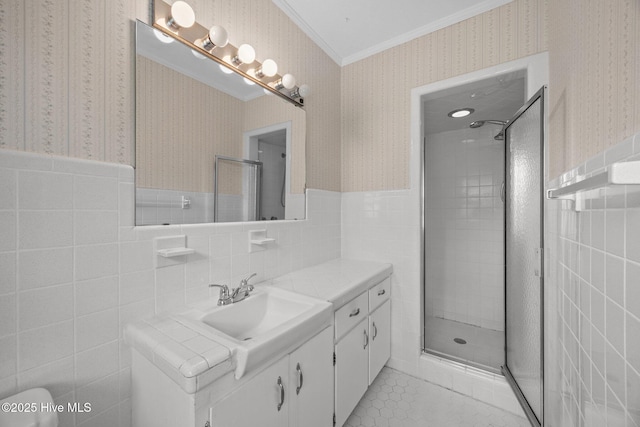 1902 York St, Kinston, NC 28504 - bathroom with wallpapered walls, tile walls, crown molding, vanity, and wainscoting