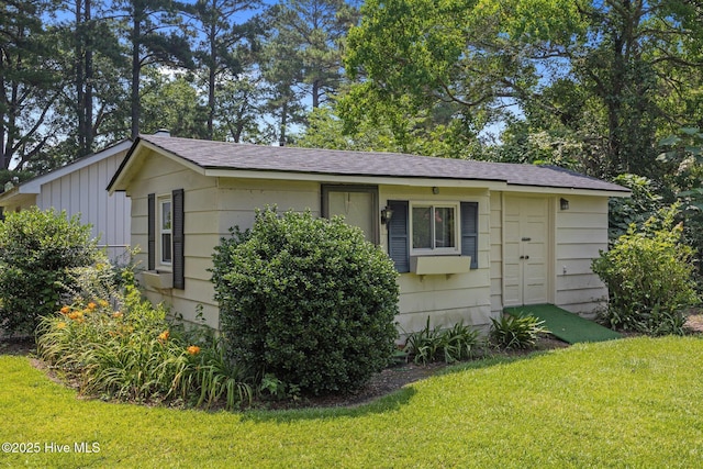 1902 York St, Kinston, NC 28504 - view of side of property with a yard, a shingled roof, and board and batten siding