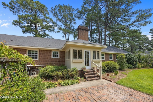 1902 York St, Kinston, NC 28504 - view of front facade featuring brick siding, a chimney, entry steps, and a front lawn