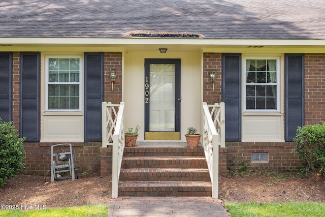 1902 York St, Kinston, NC 28504 - doorway to property with a shingled roof and brick siding