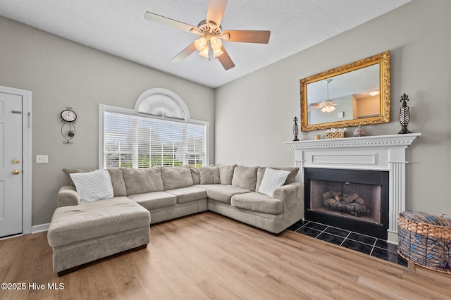 2824 Preston Ln, Grimesland, NC 27837 - living area featuring wood finished floors, ceiling fan, a fireplace with flush hearth, and a textured ceiling