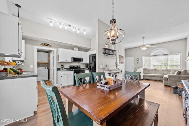 2824 Preston Ln, Grimesland, NC 27837 - dining room featuring washer / clothes dryer, a ceiling fan, a chandelier, light wood-style floors, and a textured ceiling