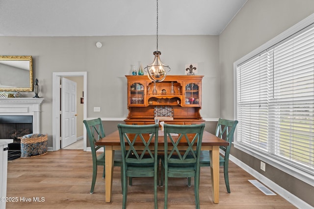 2824 Preston Ln, Grimesland, NC 27837 - dining space featuring plenty of natural light, light wood-type flooring, and a fireplace