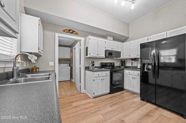 2824 Preston Ln, Grimesland, NC 27837 - kitchen featuring fridge with ice dispenser, black range with electric cooktop, washer / dryer, stainless steel microwave, and light wood-style floors