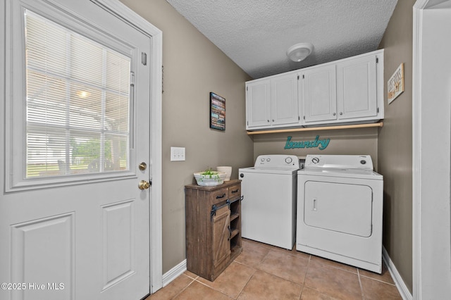2824 Preston Ln, Grimesland, NC 27837 - washroom with washing machine and clothes dryer, cabinet space, light tile patterned floors, and a textured ceiling
