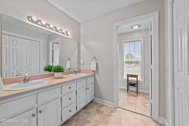 2824 Preston Ln, Grimesland, NC 27837 - bathroom featuring double vanity, a closet, tile patterned floors, and a textured ceiling