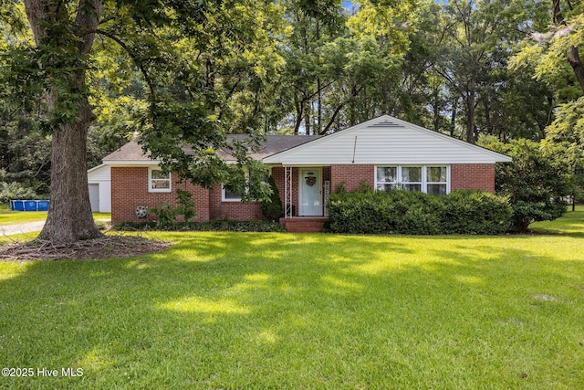 203 James St, Vanceboro, NC 28586 - ranch-style house featuring brick siding, a front yard, and a garage