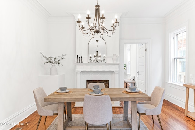 503 S 3rd St, Wilmington, NC 28401 - dining room featuring a chandelier, crown molding, wood finished floors, and a fireplace