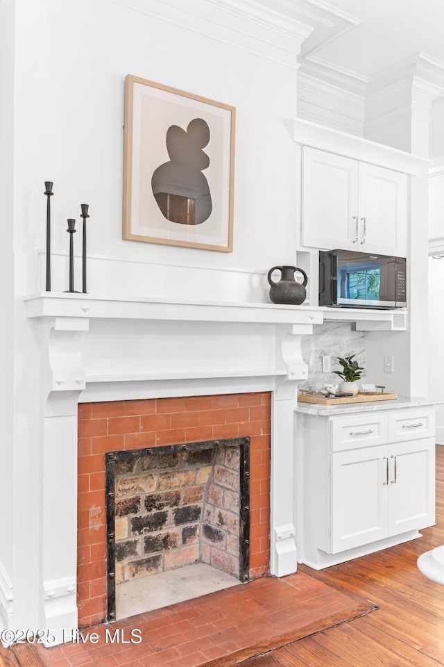 503 S 3rd St, Wilmington, NC 28401 - detailed view of ornamental molding, a fireplace with flush hearth, and wood finished floors