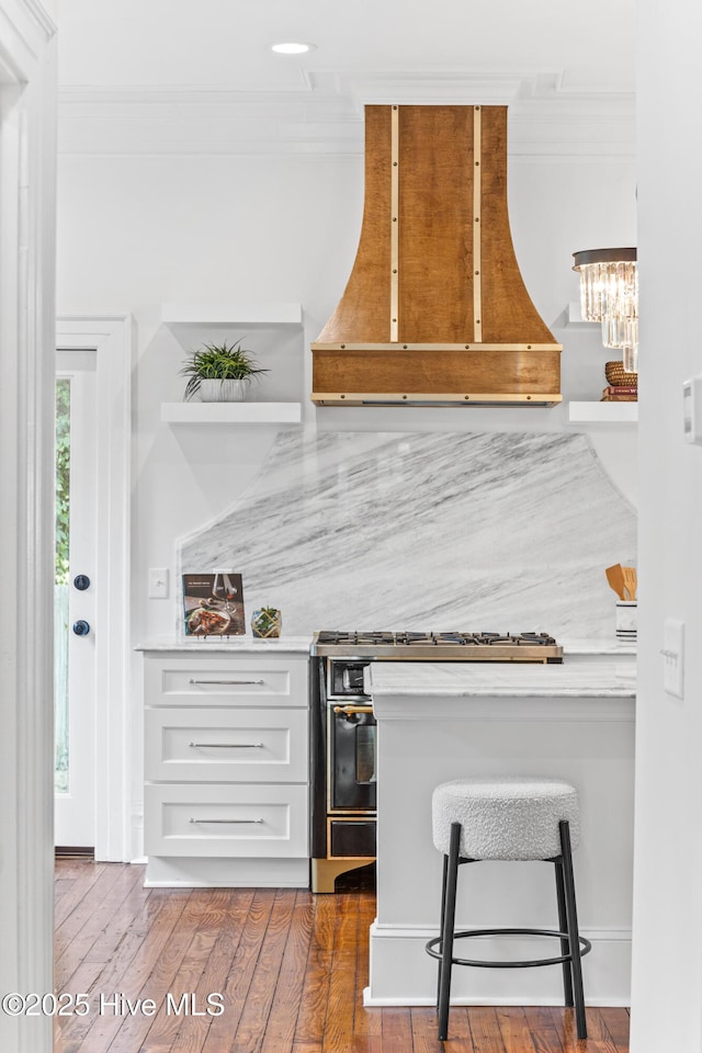 503 S 3rd St, Wilmington, NC 28401 - bar area with ventilation hood, gas range oven, ornamental molding, and hardwood / wood-style floors