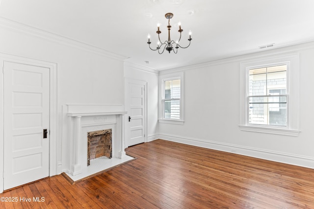 503 S 3rd St, Wilmington, NC 28401 - unfurnished living room featuring a chandelier, wood finished floors, crown molding, and a fireplace with flush hearth