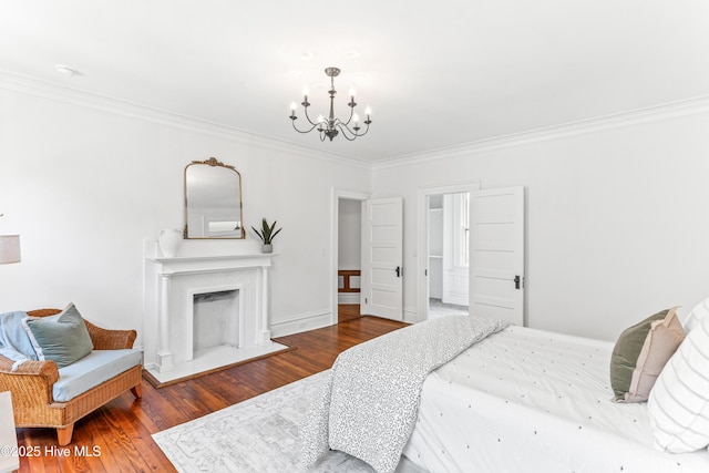 503 S 3rd St, Wilmington, NC 28401 - bedroom featuring a chandelier, crown molding, wood finished floors, and a fireplace
