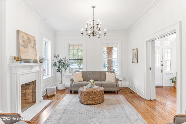 503 S 3rd St, Wilmington, NC 28401 - living room featuring hardwood / wood-style flooring, a chandelier, crown molding, and a fireplace with flush hearth