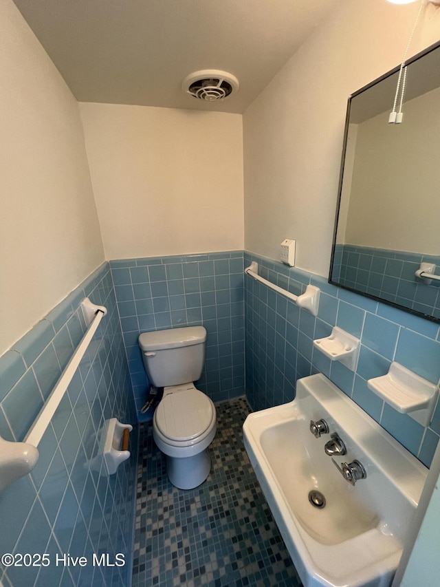 148 N Mitchell Ford Rd, Clarkton, NC 28433 - half bath with tile walls, a wainscoted wall, and tile patterned flooring