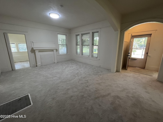 148 N Mitchell Ford Rd, Clarkton, NC 28433 - unfurnished living room with healthy amount of natural light, carpet, and arched walkways