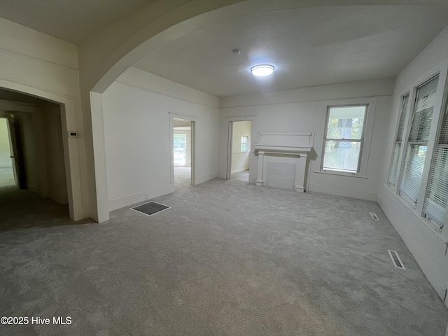 148 N Mitchell Ford Rd, Clarkton, NC 28433 - unfurnished living room featuring arched walkways and carpet