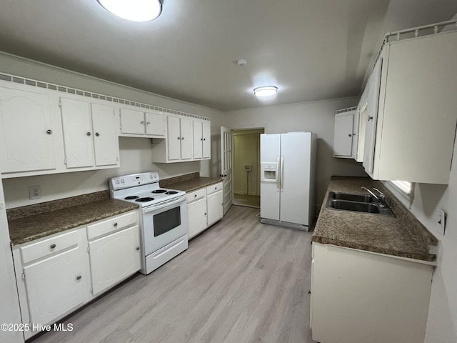 148 N Mitchell Ford Rd, Clarkton, NC 28433 - kitchen with white appliances, dark countertops, white cabinets, and light wood-type flooring