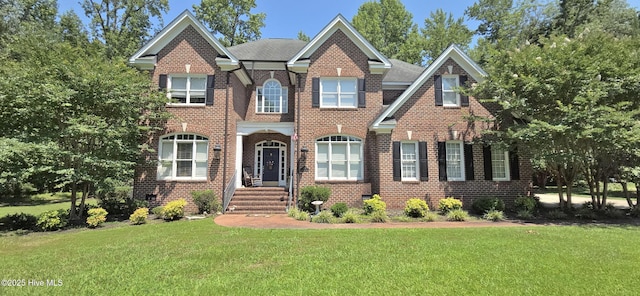 3129 Lake Pointe Trl, Rocky Mount, NC 27804 - colonial inspired home with a front lawn and brick siding
