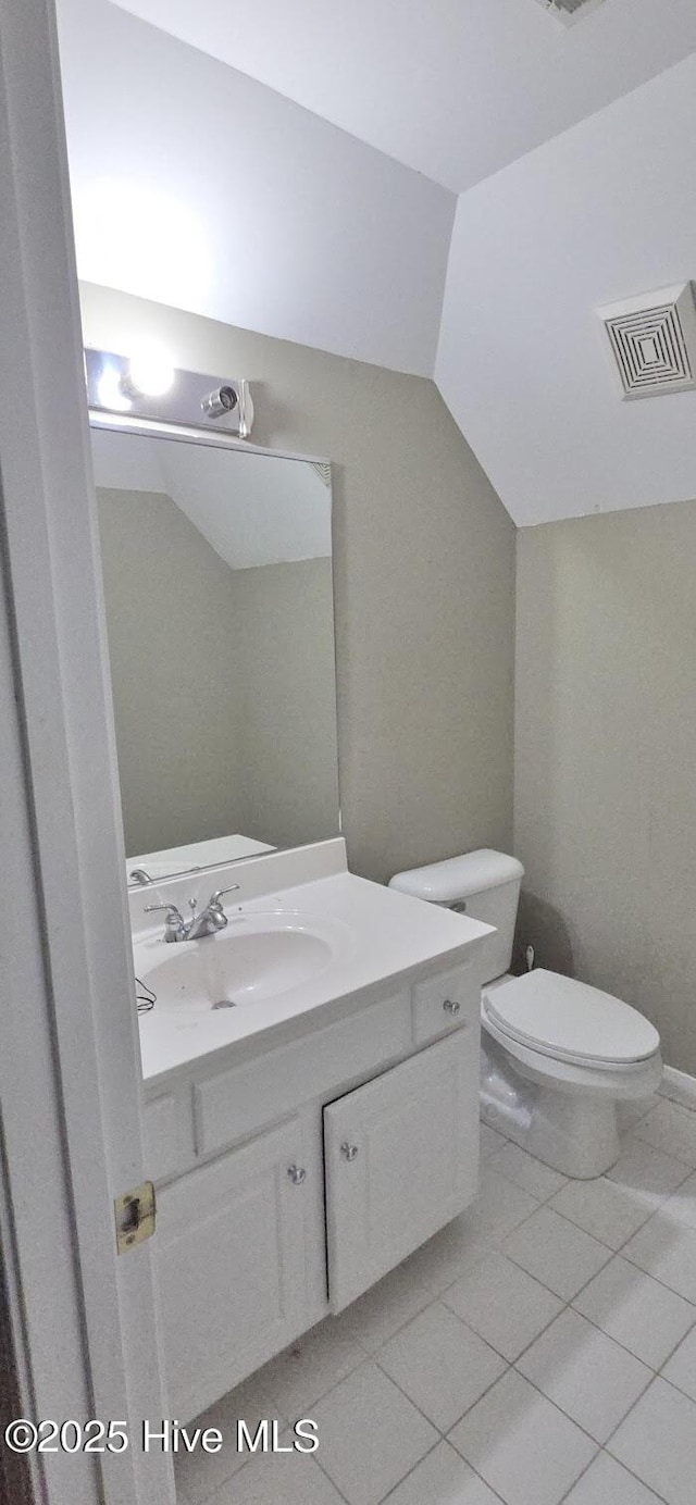 3129 Lake Pointe Trl, Rocky Mount, NC 27804 - half bath with vanity, vaulted ceiling, and tile patterned floors