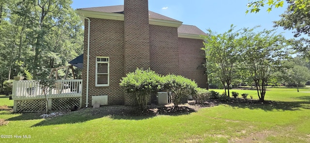 3129 Lake Pointe Trl, Rocky Mount, NC 27804 - view of side of property with brick siding, a yard, and a deck