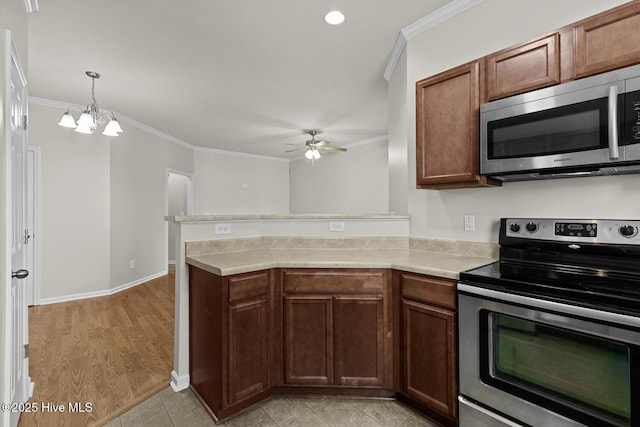 231 Glenhaven Ln, Jacksonville, NC 28546 - kitchen featuring stainless steel appliances, ornamental molding, ceiling fan, light countertops, and a peninsula