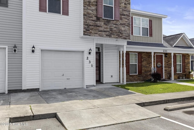 231 Glenhaven Ln, Jacksonville, NC 28546 - townhome / multi-family property featuring stone siding, board and batten siding, a garage, and a shingled roof