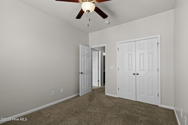 231 Glenhaven Ln, Jacksonville, NC 28546 - unfurnished bedroom with dark colored carpet, a closet, and a ceiling fan