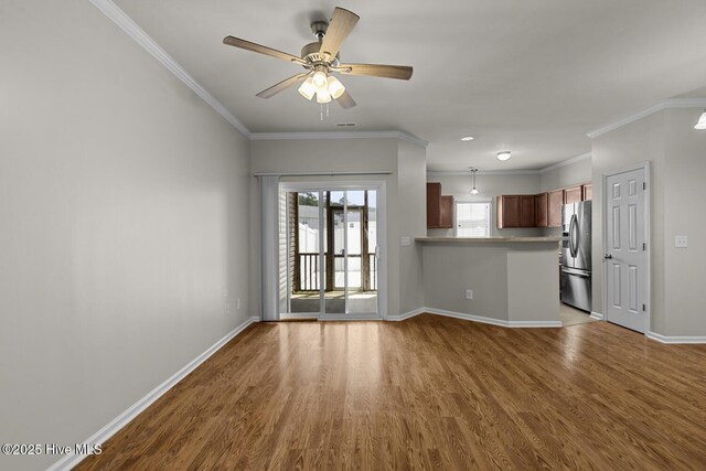 231 Glenhaven Ln, Jacksonville, NC 28546 - unfurnished living room with wood finished floors, ornamental molding, and ceiling fan