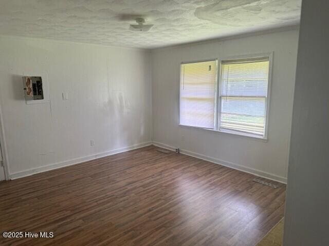513 Hall Siding Rd, Ahoskie, NC 27910 - empty room with wood finished floors and a textured ceiling